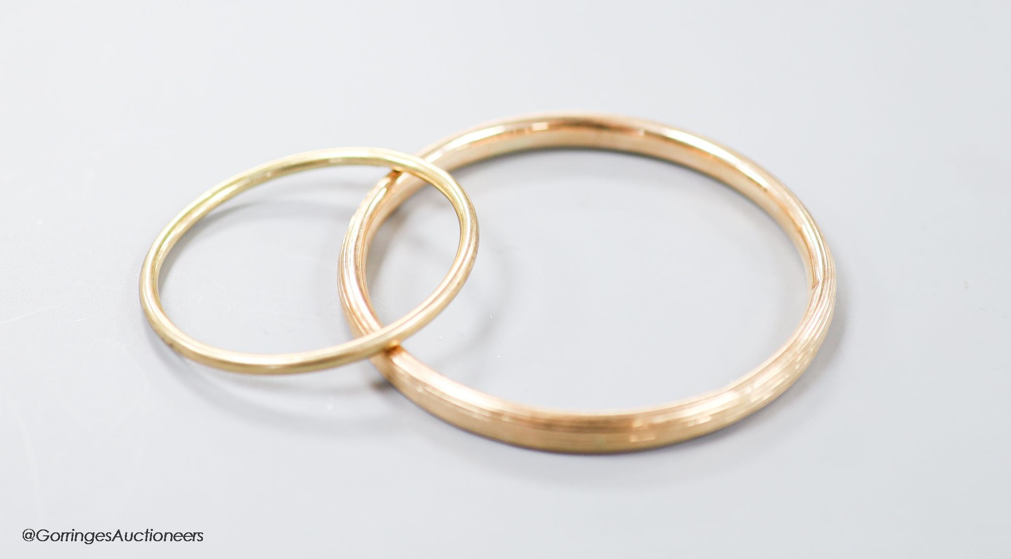 Two yellow metal bangles, the smallest stamped 9ct